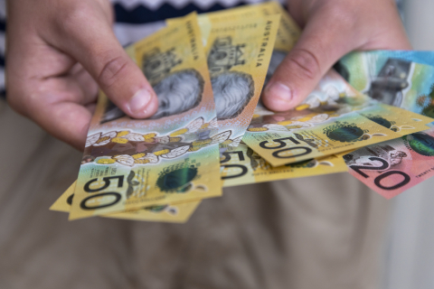 person holding australian dollars