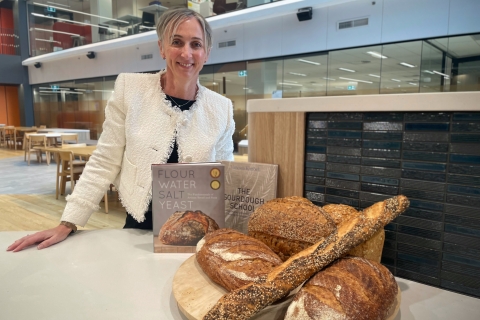 Associate Professor Sara Grafenauer posing with bread and cookbooks