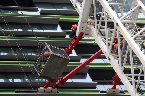 opal_tower_workers_on_a_crane_outside_the_building.jpg
