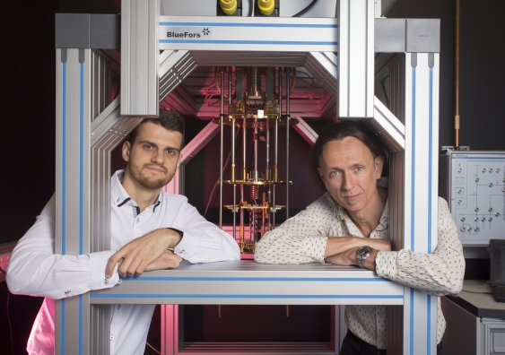 Dr Guilherme Tosi and Professor Andrea Morello at the UNSW quantum computing labs with a dilution refrigerator, which cools silicon chips down to 0.01 ̊ above absolute zero. Photo: Quentin Jones