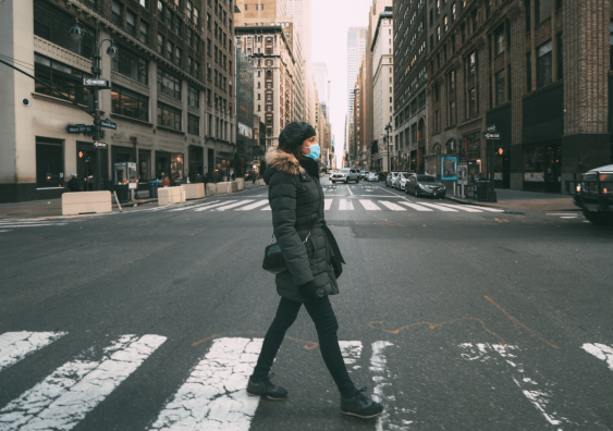 Young woman crossing street