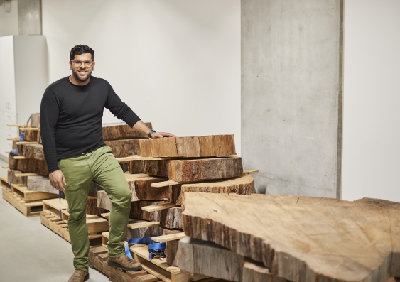 Dr. Adam Sookdeo with pieces of ancient Kauri trees