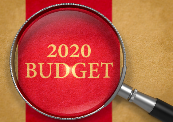 Magnifying glass over words 2020 budget.