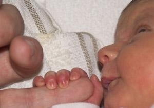 Tiny baby holding hand
