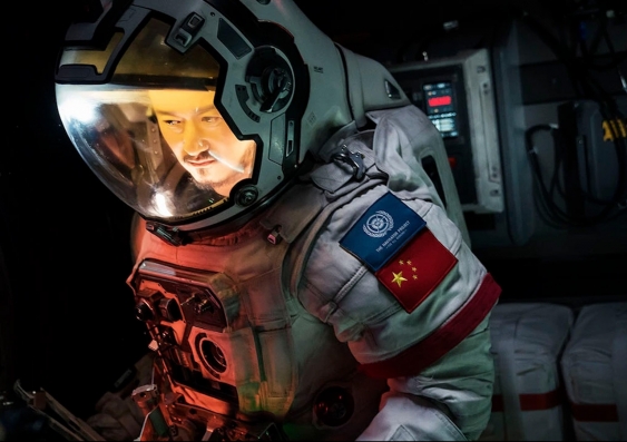 a chinese man in a space suit in a scene from the movie.
