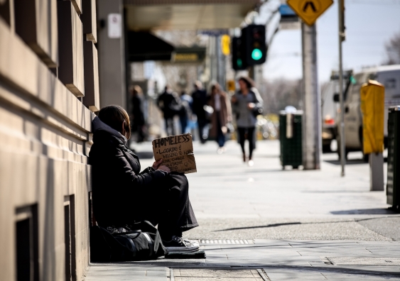 a homeless person sitting on the street