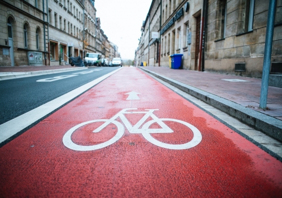 a red cycling lane in a city
