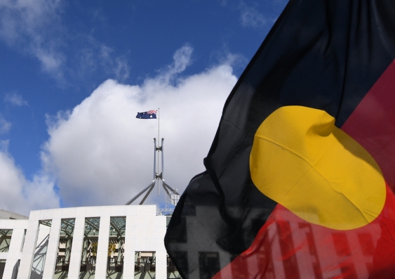 aboriginal flag and australian flag flying at parliament house canberra