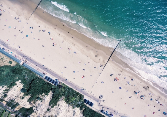 aerial drone shot of a beach with people