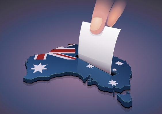 an illustration of a hand lowering a voting paper onto a map of australia