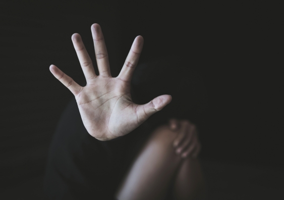 an outstreached hand against a dark background