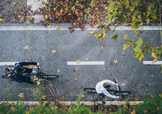 birdseye shot of two people riding bikes on a cycle path