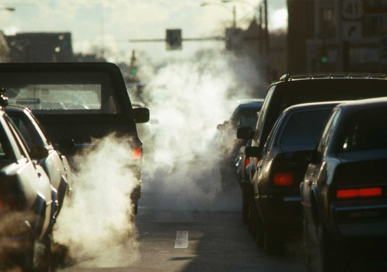 Cars in a traffic with visible pollution. 