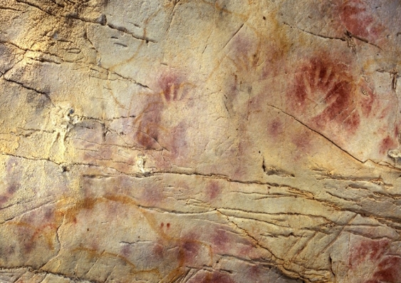 Handprints outlined by red ochre on a cave wall