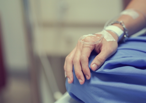 Close-up of a person's hand receiving a drip in a hospital setting