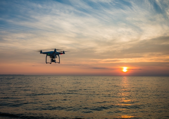 drone flying on the beach at sunset