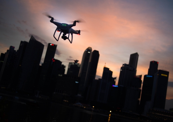 drone flying over city at dusk