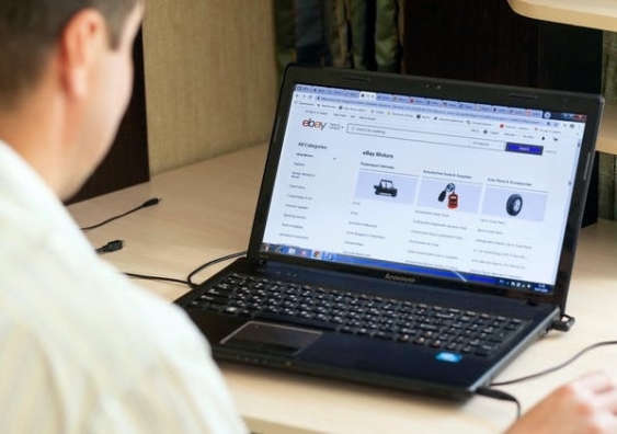 A person shopping online on a laptop