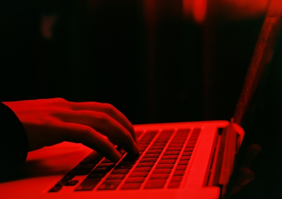 Shot of a hacker using a laptop