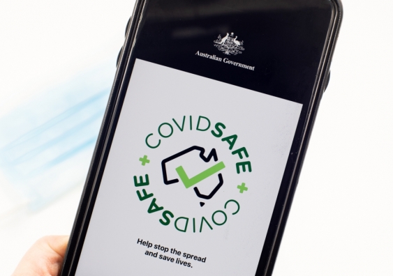 Hand holding phone with CovidSafe app open