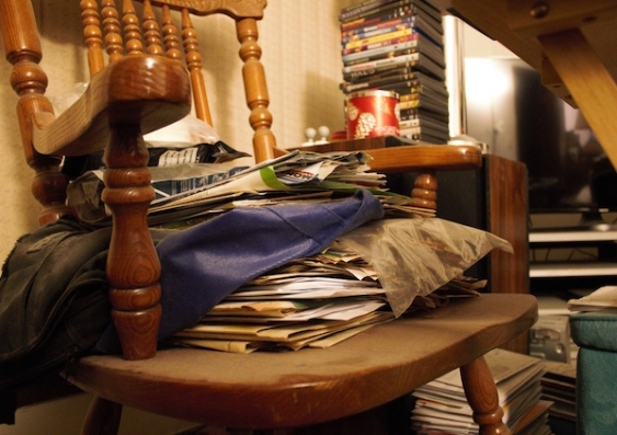 A chair stacked with belongings cannot be used