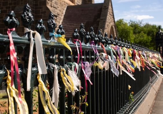 hundreds of colourful ribbons attached to the fence of st patricks catholic cathedral