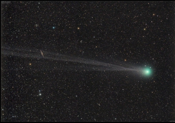 A comet with a green coma and two white tails