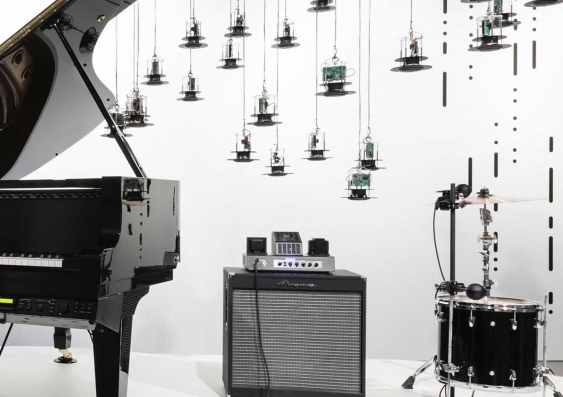 museum sound installation featuring piano, amplifier, drum with cymbal and lights