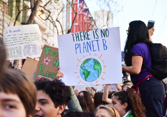 Young protesters hold a sign saying There is no Planet B