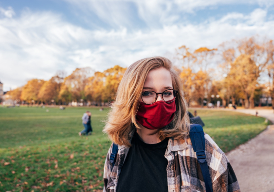 Young woman wears a face mask outdoors