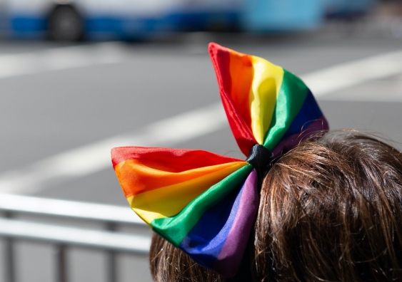 person with a rainbow bow in hair