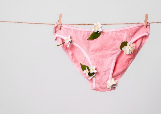 pink underpants decorated with flowers hanging on a clothes line.