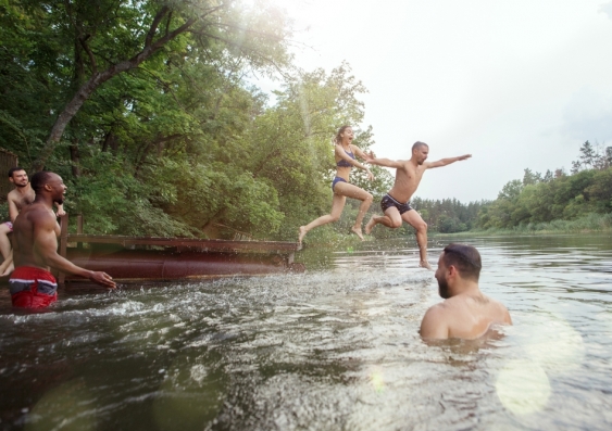 People jumping into river