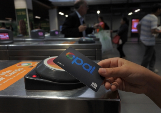 scanning an opal card reader at a train barrier