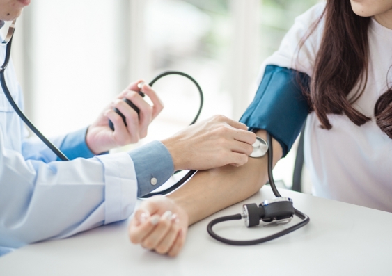 doctor measuring patient's blood pressure
