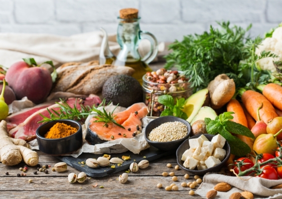  Assortment of healthy food ingredients for cooking on a wooden kitchen table. 