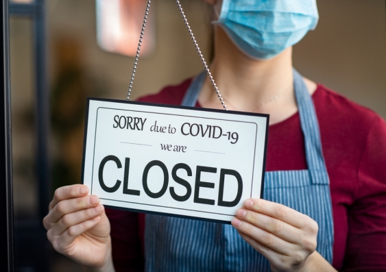 Woman closing shop due to COVID-19