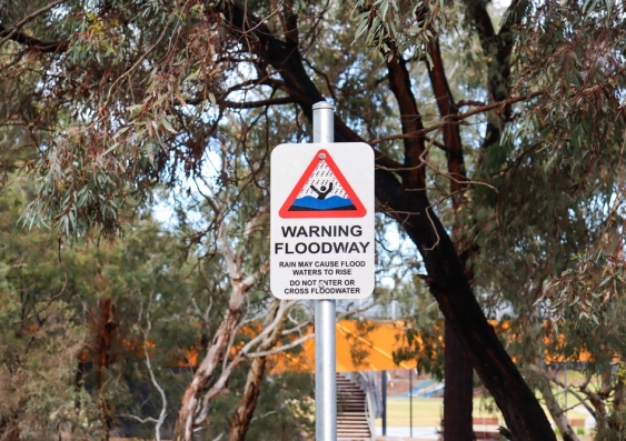 Floodway warning sign in parkland on Werribee River