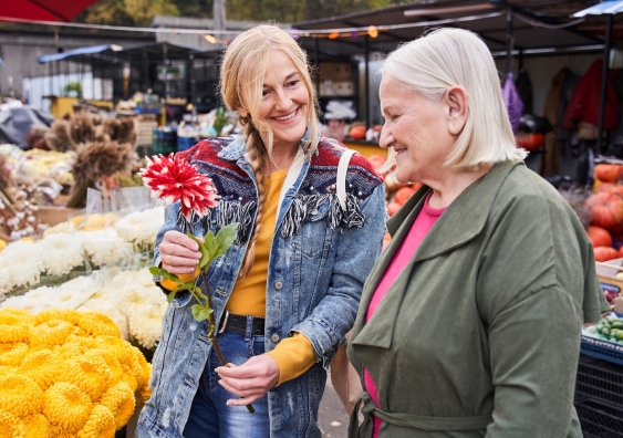 Younger woman at markets with older woman