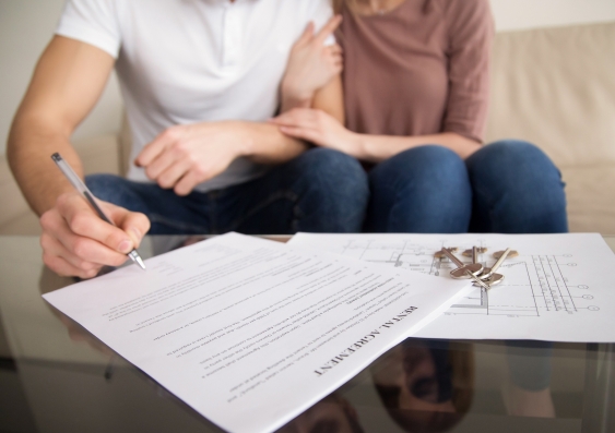 Young couple signing a tenancy rental agreement