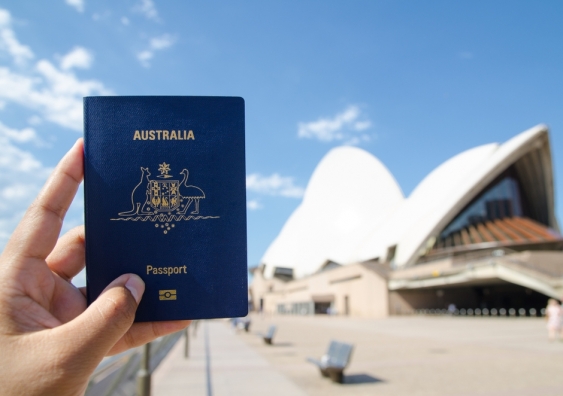 Australian passport held in front of the Sydney Opera House
