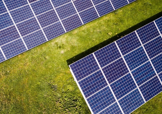 solar panels in bright and warm sunlight seen from above