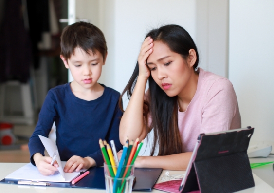 Stressed mother homeschooling her child