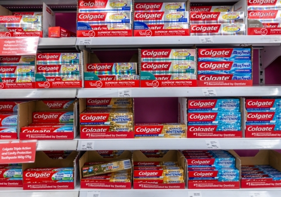Supermarket shelf packed with different types of Colgate toothpaste