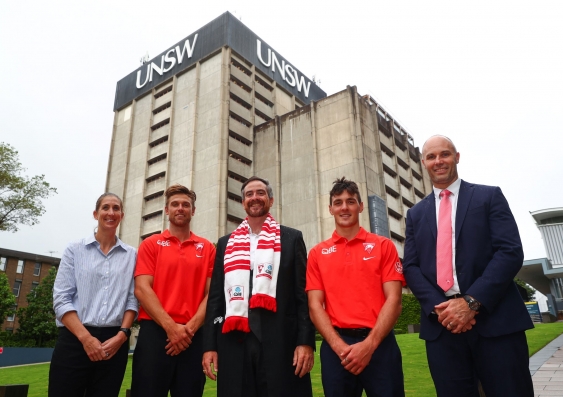 Sydney Swans players and executive with UNSW Vice-Chancellor and President Atilla Brungs