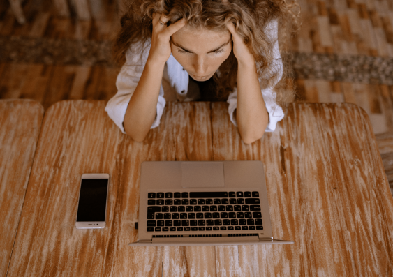 Woman stressed at computer.png