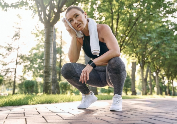 Woman exercising in a park stops to take a break