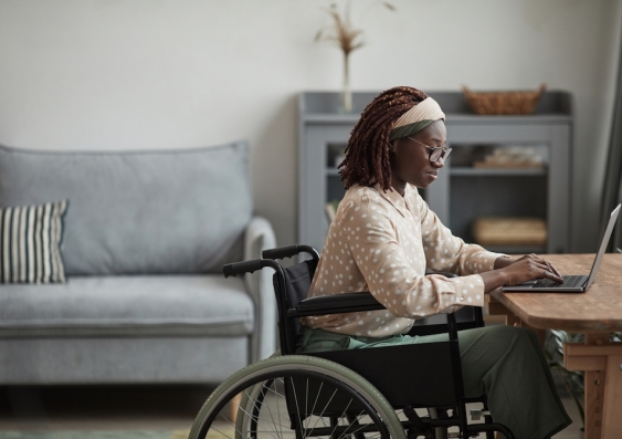 Woman in wheelchair using her laptop