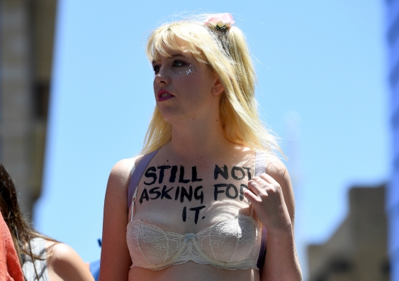 woman with 'still not asking for it' written on her chest above her bra