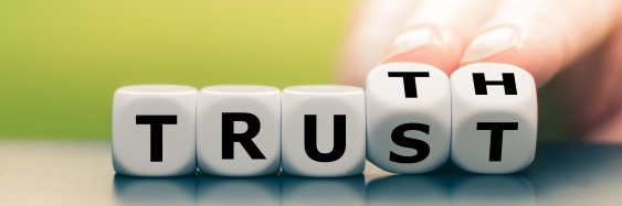 Five cubes with the last two letters alternating to spell either TRUST or TRUTH
